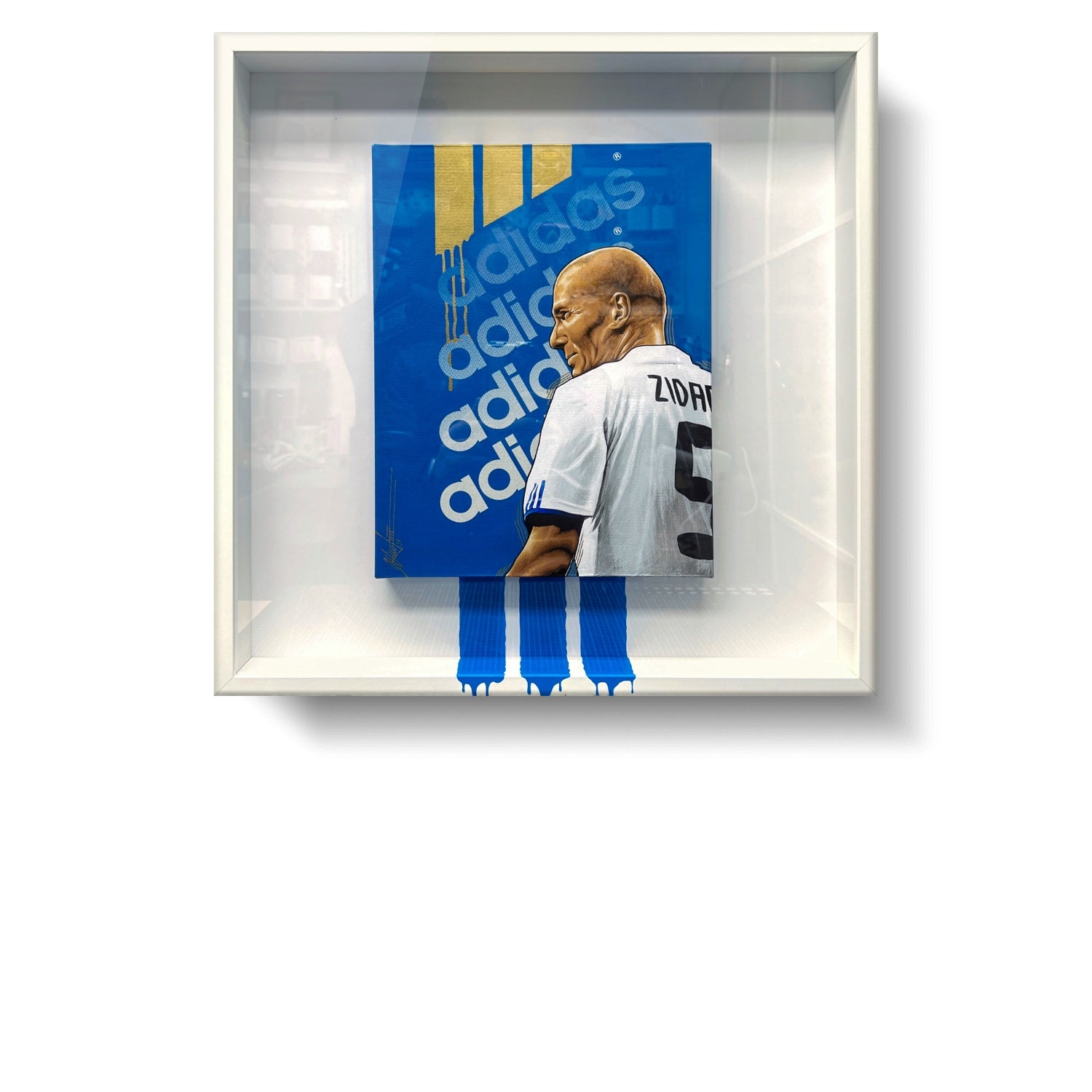 Fotografía de la obra enmarcada en cuadro cuadrado de 50x50cm y marco blanco.