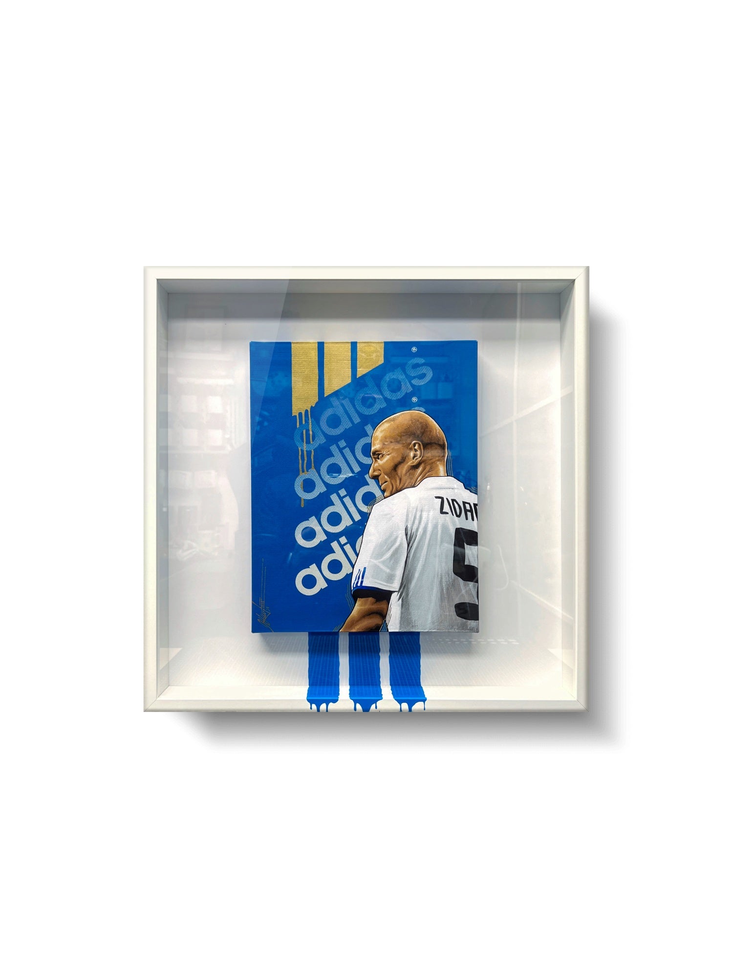 Fotografía de la obra enmarcada en cuadro cuadrado de 50x50cm y marco blanco.