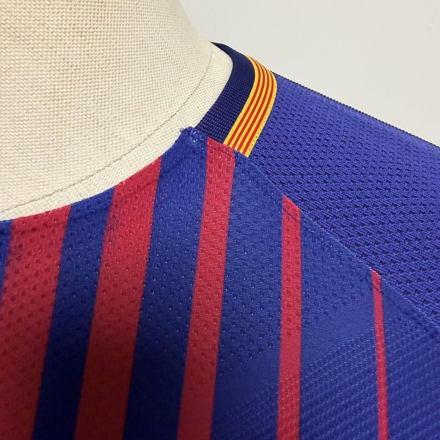 Plano detalle de las costuras del cuello y de la tira con la bandera catalana (vista lateral izquierda)