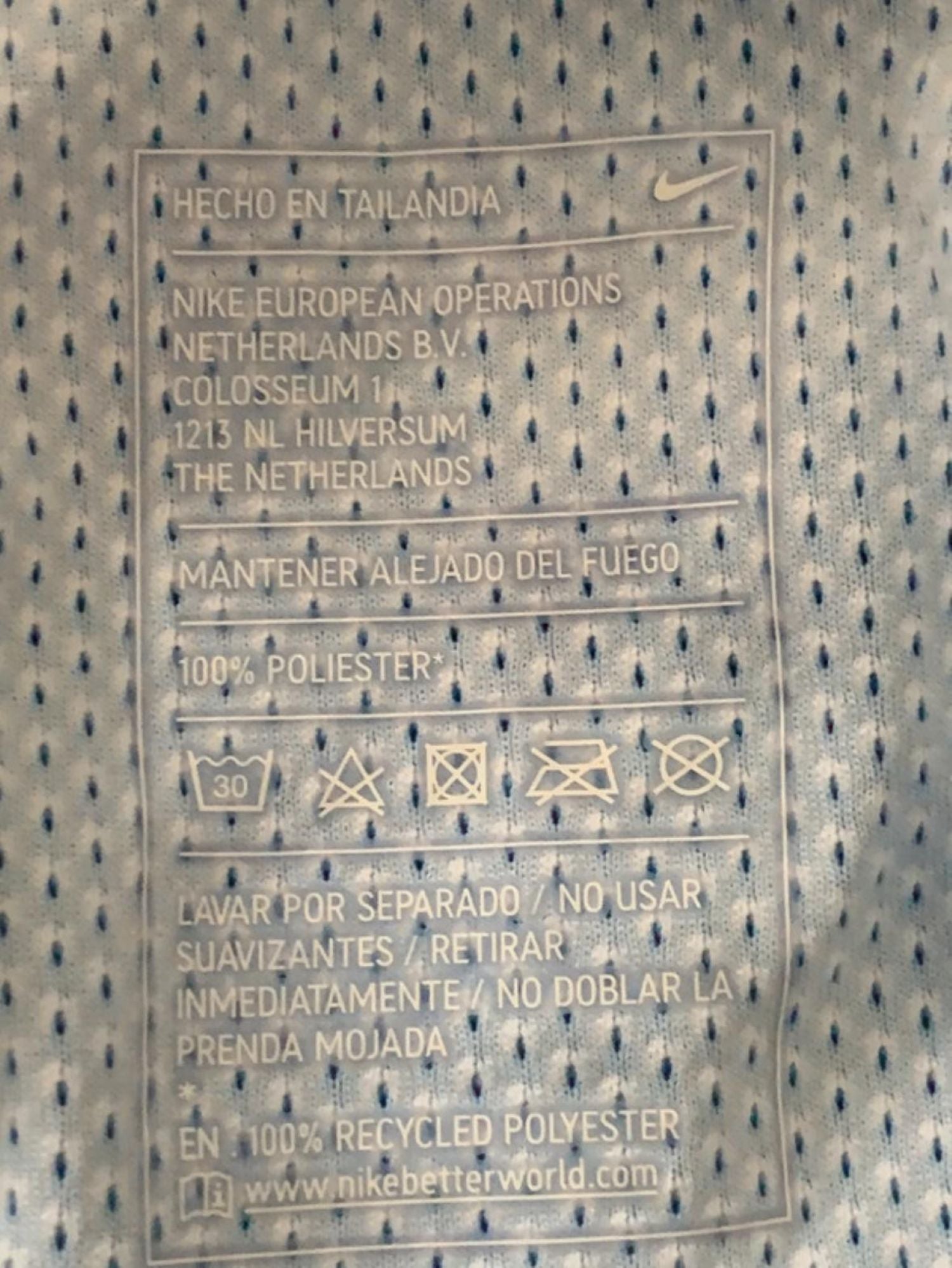 Plano detalle de la etiqueta interior de  nike de la camiseta. Hecho en Tailandia