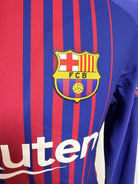 Plano detalle del escudo del FCB, del tejido de la camiseta y separación sobre serigrafía sponsor Rakuten